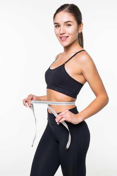 young fitness woman measure with tape her belly isolated white wall (2) (1)